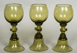 Three green glass roemers Each with plain bowl, raspberry prunt baluster stem and domed foot.