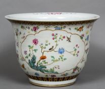 A Chinese porcelain jardiniere Worked with floral vignettes within floral sprays. 33 cm high.