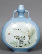 A Chinese porcelain moon flask Decorated with a man and his horse opposing a river landscape,