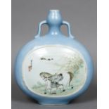 A Chinese porcelain moon flask Decorated with a man and his horse opposing a river landscape,