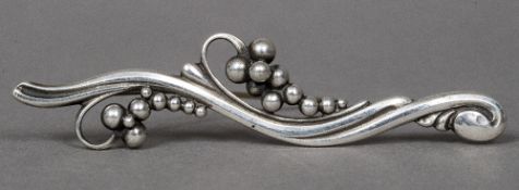 A Georg Jensen Danish Sterling silver brooch Of beaded scrolling form, stamped number 275.