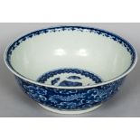 A Chinese blue and white porcelain bowl Decorated with dragons amongst stylised clouds,