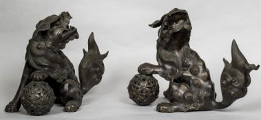 A pair of 19th century Chinese patinated bronze models of dogs-of-fo Each typically formed with