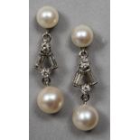 A pair of 14 ct white gold diamond set and pearl mounted drop earrings 3 cm long.