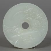 A Chinese carved white jade bi disc Worked with quails. 5.5 cm diameter.