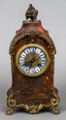 A boulle cased mantel clock The enamelled sectional dial with Roman numerals,