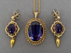 A 14 ct gold framed amethyst set pendant Mounted on a 9 ct gold chain;