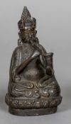 An Eastern patinated bronze figure of a deity Formed blowing a prayer horn. 12.75 cm high.