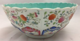 A 19th century Chinese porcelain bowl With shaped rim above fruiting sprays and floral painted