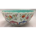 A 19th century Chinese porcelain bowl With shaped rim above fruiting sprays and floral painted