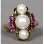 A mid 20th century 18 ct gold pearl and ruby ring The three central pearls flanked by two rows of