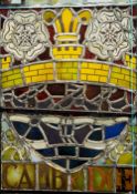 A stained glass panel Worked with the Cambridge City coat-of-arms and inscribed Cambridge, framed.