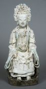 A Chinese Song dynasty part celadon glazed blanc de chine porcelain figure of Guanyin Typically