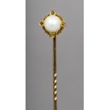 An unmarked gold pearl and diamond set stick pin The central pearl flanked by four small diamonds.