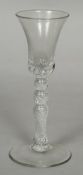 An 18th century air twist wine or gin glass The trumpet bowl with baluster stem and spreading foot.