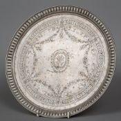 A Russian silver salver Of circular form with a beaded rim and engraved with bow tied floral swags