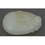 A Chinese carved white jade pebble Surmounted with the figure of a monkey. 5.5 cm wide.