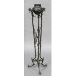 After the antique, a cast and wrought iron brazier on stand The uprights with mythical beast masks,