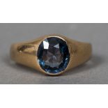 An unmarked 14 ct gold ring The band set with a central blue stone.