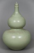 A Chinese porcelain double gourd vase and stopper With allover celadon glaze,