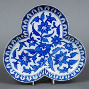 An Iznik style trefoil dish Decorated with floral sprays. 25 cm wide.