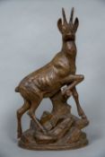 A 19th century Black Forest carving of a chamois Worked atop a rocky outcrop. 62.5 cm high.