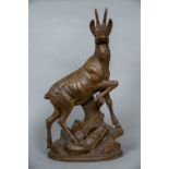 A 19th century Black Forest carving of a chamois Worked atop a rocky outcrop. 62.5 cm high.