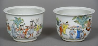 A pair of small Chinese porcelain jardinieres Each decorated with figures in a fenced garden and