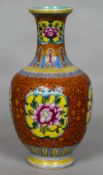 A Chinese porcelain baluster vase Decorated with floral vignettes within lotus strapwork,