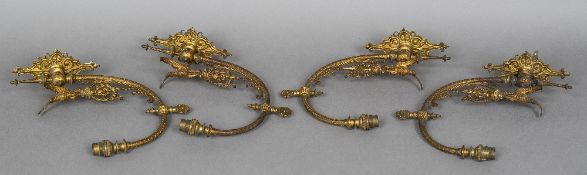 A set of four Victorian gilt bronze wall sconces Each with a single scrolling branch surmounted
