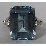 A 14 ct white gold diamond and aquamarine set ring The central stone emerald cut,