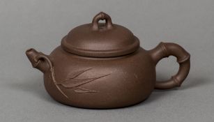 A Chinese Yixing pottery teapot and cover Impressed archaistic seal mark to base;