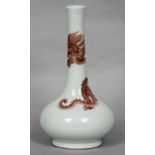 A Chinese porcelain bottle vase Iron red decorated with a dragon,