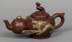 A Chinese Yixing pottery teapot Modelled as graduated teapots united by dragons,