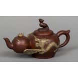 A Chinese Yixing pottery teapot Modelled as graduated teapots united by dragons,