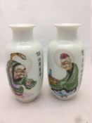 A pair of Chinese porcelain vases Each decorated with an elderly sage opposing calligraphic script