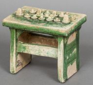 A Chinese Tang style pottery model of an offertory table With green glazed decoration. 18 cm wide.