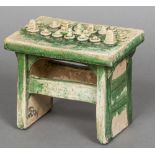 A Chinese Tang style pottery model of an offertory table With green glazed decoration. 18 cm wide.