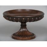 A turned and carved mahogany tazza The fluted shallow bowl supported on the reeded spreading column