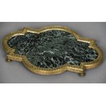 A French Empire ormolu mounted green variegated marble plateau Of shaped rectangular form with