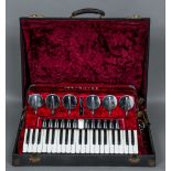 A Scandalli piano accordion Of typical form, in mottled red casing,