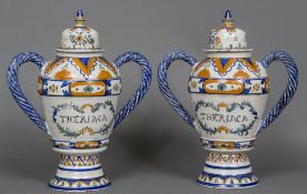 A pair of Continental polychrome decorated lidded drug jars Each with twin rope twist loop handles,