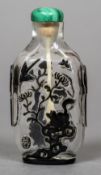 A Chinese cameo glass snuff bottle Decorated with birds and animals and with twin mask handles and