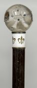 An 18 ct gold mounted and enamelled parasol The glass pommel bejewelled. 90 cm long.