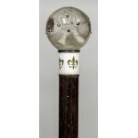 An 18 ct gold mounted and enamelled parasol The glass pommel bejewelled. 90 cm long.