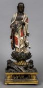 An 18th century Chinese carved wooden figure of Buddha Modelled standing in flowing robes holding a