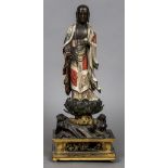 An 18th century Chinese carved wooden figure of Buddha Modelled standing in flowing robes holding a
