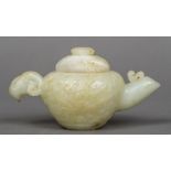 A Chinese carved pale and russet jade water dropper and cover The handle worked as a ram's mask,
