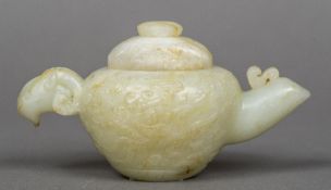 A Chinese carved pale and russet jade water dropper and cover The handle worked as a ram's mask,