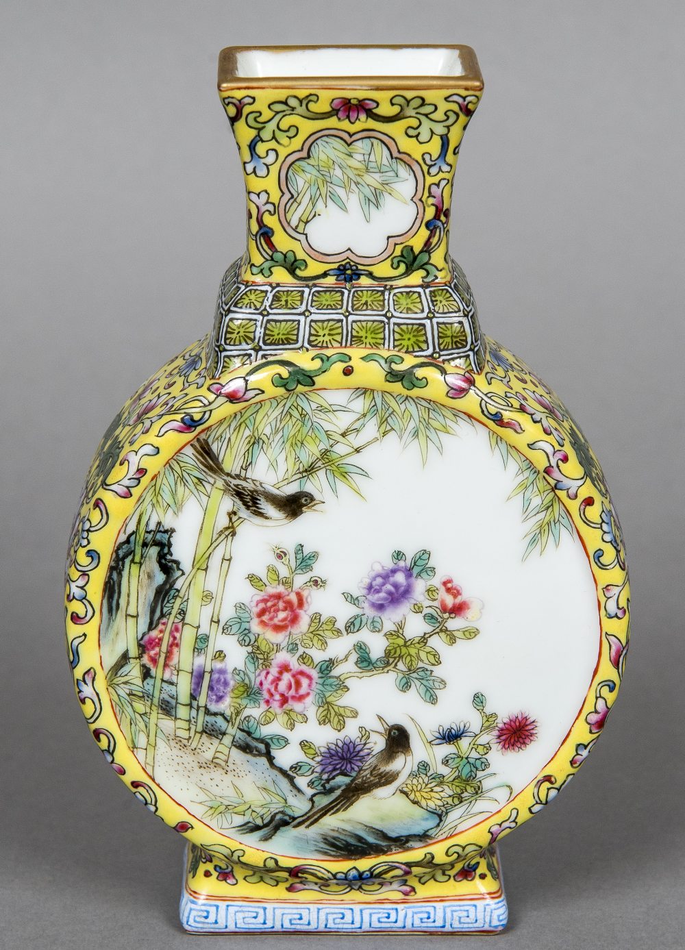 A Chinese porcelain moon flask Decorated with bird vignettes within lotus strapwork on a yellow